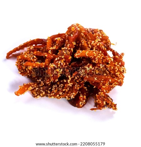 dried squid with sesame seeds and peppers on a white background