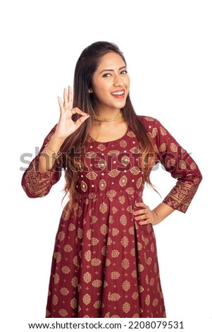 Happy young woman showing hand sign isolated on white.