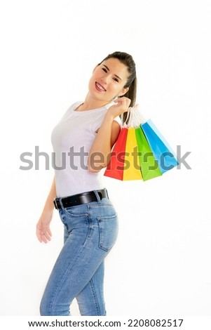 Happy woman holding colorful bags over her shoulder on a white background - concept of shopping, sales, black friday, christmas