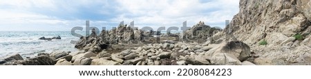 sharp jagged basalt rocks on the sea coast, Cape Stolbchaty on Kunashir Island Royalty-Free Stock Photo #2208084223