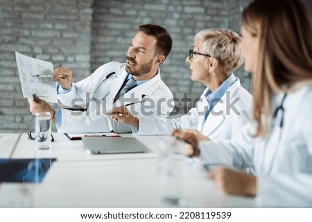 Group of doctors  analyzing medical data while having a meeting in the office