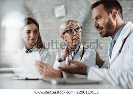 Group of doctors  analyzing medical data while having a meeting in the office
