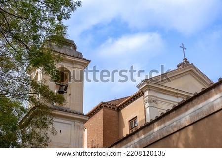 Side View with the Bell Tower of the Basilica of San Clemente in the Center of Rome on a Background of Partly Cloudy Sky Royalty-Free Stock Photo #2208120135