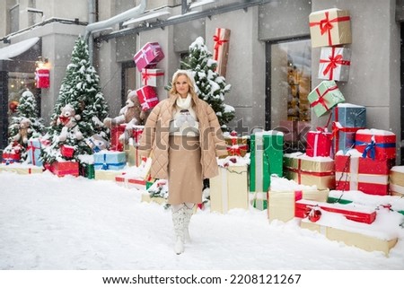 A young woman in winter against the background of Christmas decorations with a New Year's mood