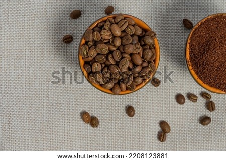 Ground and whole-grain coffee on a light background, top view of coffee, copy space.