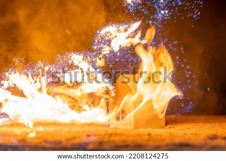 The house is engulfed in flames. The concept of a house fire. Background picture.