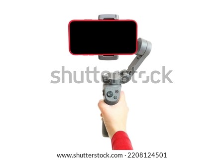 Shooting smartphone video using a handheld gimbal stabilizer isolated on white background Royalty-Free Stock Photo #2208124501