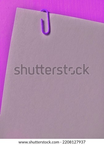 Paper with paperclip on wood desk for text template.