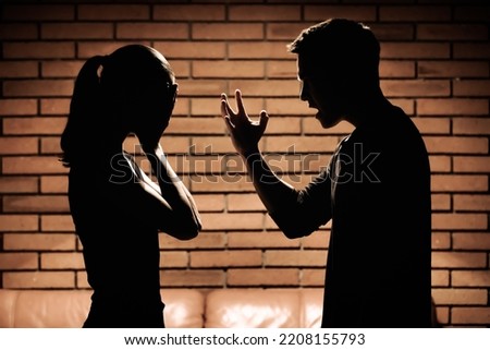 Man screaming verbal insults to woman. Domestic abuse and bad relationship concept.  Royalty-Free Stock Photo #2208155793