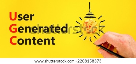 UGC user generated content symbol. Concept words UGC user generated content on a beautiful yellow background. Orange light bulb icon. Business and UGC user generated content concept. Copy space. Royalty-Free Stock Photo #2208158373