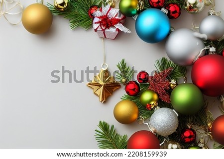 Colorful christmas baubles with fir tree branches on white background