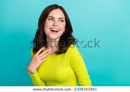 Closeup photo of young attractive pretty woman hold hand chest laugh comic smiling look empty space joke isolated on aquamarine color background