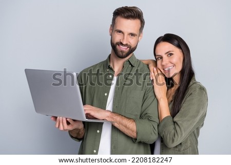 Portrait of attractive cheerful couple cuddling using laptop web freelance isolated over grey pastel color background Royalty-Free Stock Photo #2208182247