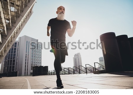 Photo of focused dedicated man run forward goal race participant concept wear t-shirt urban town outdoors