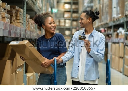 African-American couple and an Asian husband shop for home furnishings and carry credit cards for convenience at wholesale stores. self service concept