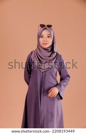 Full length portrait of a beautiful Muslim female model wearing stylish office attire with hijab isolated background. Fashion, beauty, style concept.