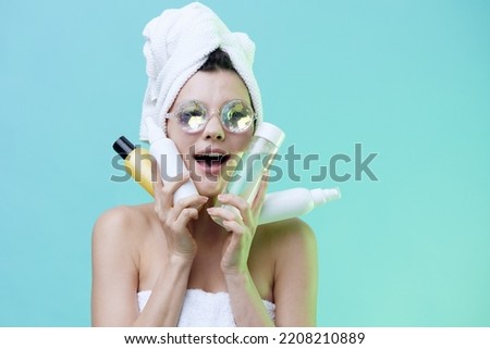 Horizontal photo, a woman with ideal smooth skin on a blue background in beautiful glasses with patches on her lips shows her best cosmetics. beautiful beauty industry