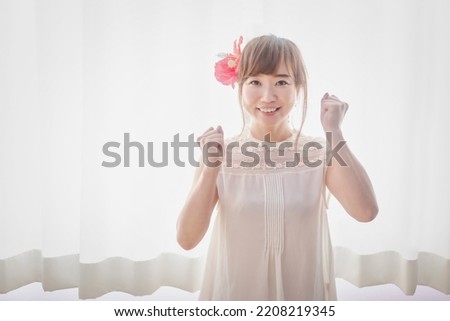 Asian woman with hibiscus hair ornament