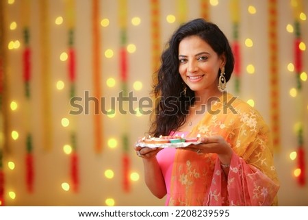 Female celebrating diwali with full of happiness Royalty-Free Stock Photo #2208239595
