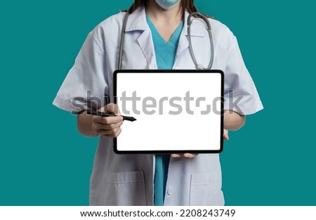 Doctor use tablet pc computer blank screen workspace isolated on green background.
