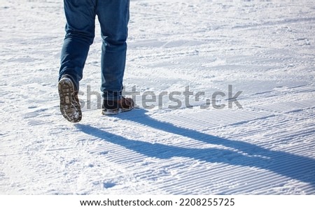 A man walks in the snow. Winter