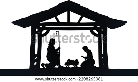 Traditional Christian Christmas Nativity Scene of baby Jesus in the manger with Mary and Joseph in silhouette 