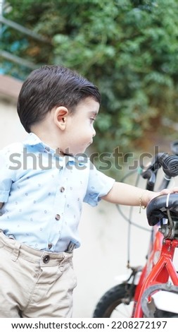 Little boy posing on his bike