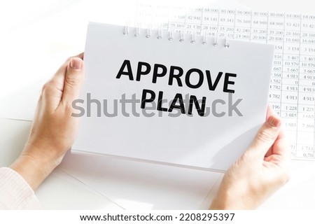 a man writes the text approve plan