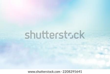 GLITTERING ICE AND BOKEH LIGHTS BACKGROUND, PASTEL BLUE WINTER BACKDROP, CHRISTMAS STILL LIFE FOR MONTAGE PRODUCSTS OR CHRISTMAS PRESENTS