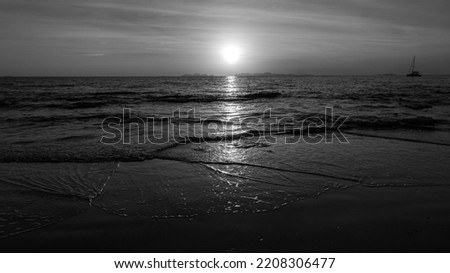 Beautiful and colourful sunset scenery over the tropical beach. Summer holidays view with a scenery of a setting sun over the sea.  