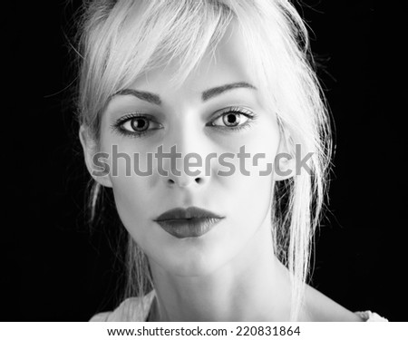 Beautiful model with blonde hair on black background. Black and white version.