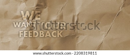 We want your feedback sign on paper background