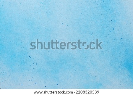 Canvas covered with light blue spray paint as background