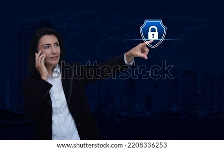 Businesswoman talking on her cell phone and pointing finger to padlock with shield icon over world map, city tower, Technology security insurance online, Elements of this image furnished by NASA