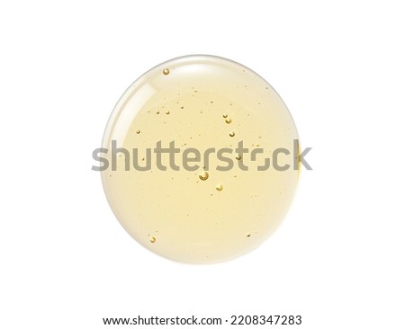 Transparent skin care liquid texture. Yellow serum and bubbles on white background. Royalty-Free Stock Photo #2208347283