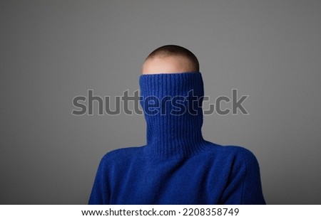 Young bald woman wears turtle neck sweater posing over light grey wall. Mock-up. Royalty-Free Stock Photo #2208358749