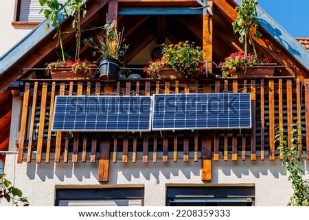Solar battery on balcony wall of vintage house in Germany. Balcony Mini photovoltaic power plant. Mini PV plants generate your own electricity plug  play.  Small Solar Panel energy system.  Royalty-Free Stock Photo #2208359333