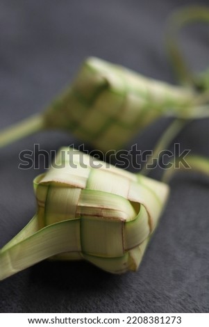 Ketupat (Rice Dumpling) Isolated Photo. 
Ketupat is a steamed rice packed inside a diamond-shaped container of woven palm leaf pouch or steamed rice casing made 
from young coconut leaves for cooking 