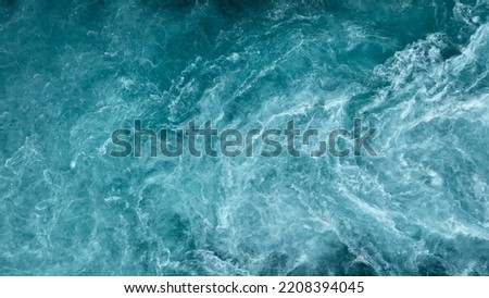 Aerial view of the waves and rapids of the wild river, close-up, top shot Royalty-Free Stock Photo #2208394045