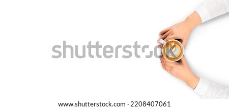 Latte art, top view photo of woman holding mug with latte art. Isolated on white background caucasian lady sitting and drinking coffee. Copy space area, cafe menu design concept idea studio image.
