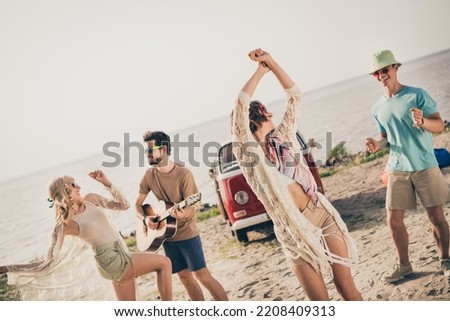 Photo of four cheerful friends road voyage camping free time coast clubbing wear casual outfit nature seaside beach outside