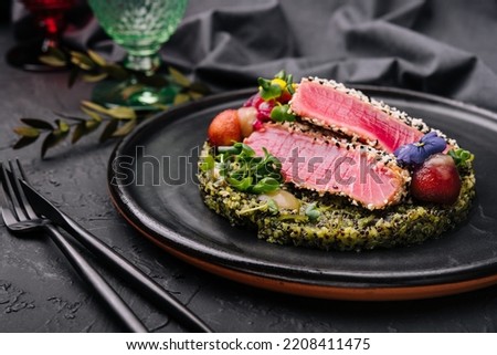Rare ahi tuna steak slices with fresh herbs Royalty-Free Stock Photo #2208411475