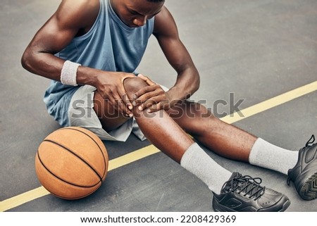 Fitness, basketball knee injury or pain while on basketball court holding leg in exercise, training or sport workout. Professional athlete, health or sports man with accident in street game or event Royalty-Free Stock Photo #2208429369