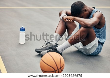 Tired, depression or sad basketball player with training gear after game fail, mistake or problem. Depressed, mental health and anxiety or stress sports, athlete teenager man frustrated with results Royalty-Free Stock Photo #2208429675