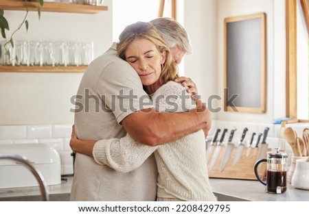 Couple, elderly and hug in kitchen in home together, romance and love. Care, man and woman in retirement love, marriage and embrace in sad moment for support, comfort and unity as married people Royalty-Free Stock Photo #2208429795