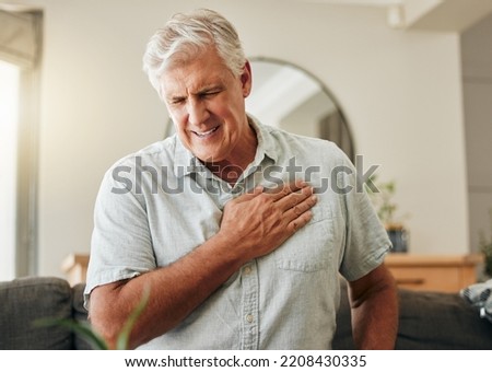 Senior man, heart attack and stroke at home for emergency health risk, breathing problem and cardiology accident. Sick elderly male with chest pain cancer, cardiovascular disease and heartburn injury Royalty-Free Stock Photo #2208430335