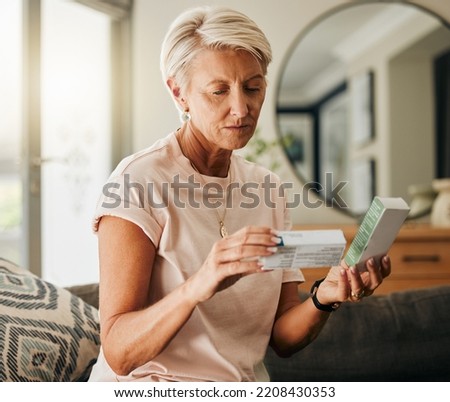 Senior woman, medicine pills and reading instructions on healthcare, medical wellness and pharmacy tablet box in house living room. Thinking retirement elderly with insurance drugs product in Sweden