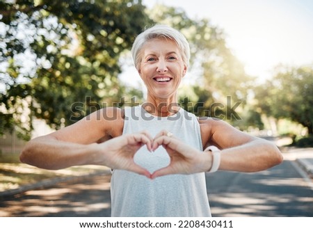 Fitness, happy and heart hands of old woman in nature after running for health, wellness and workout. Smile, motivation and peace with senior lady and sign for love, faith and training in nature Royalty-Free Stock Photo #2208430411