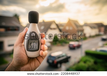 Noise pollution is measured with a meter on the street Royalty-Free Stock Photo #2208448937