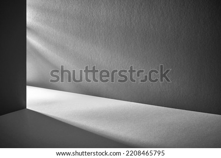Minimal abstract black background for product presentation. Organic drop diagonal shadow and rays of light from window on a blue wallpaper Royalty-Free Stock Photo #2208465795